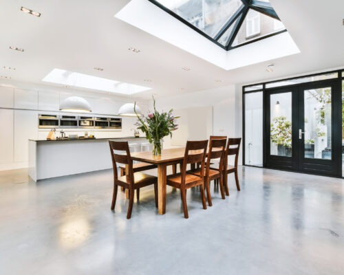 Spacious dining room with wooden chairs and table